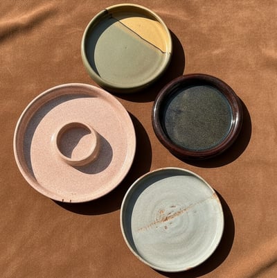 A collection of unique, irregularly shaped ceramic plates